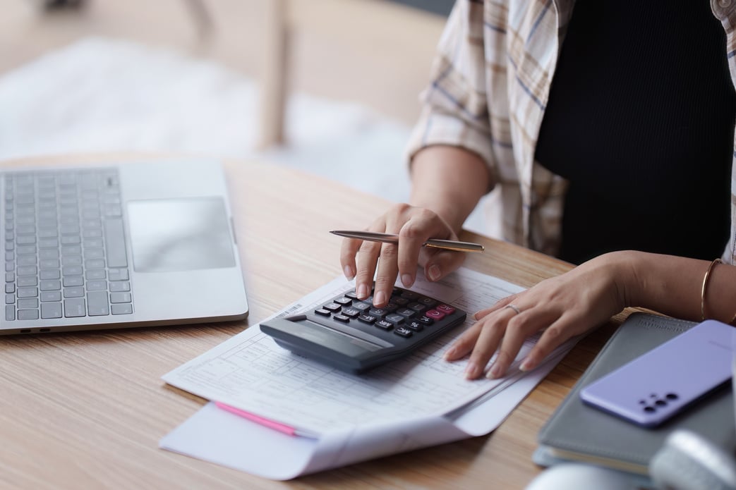 Asian accounting professional calculating household bills, reviewing and analyzing household bills, and filing tax returns.